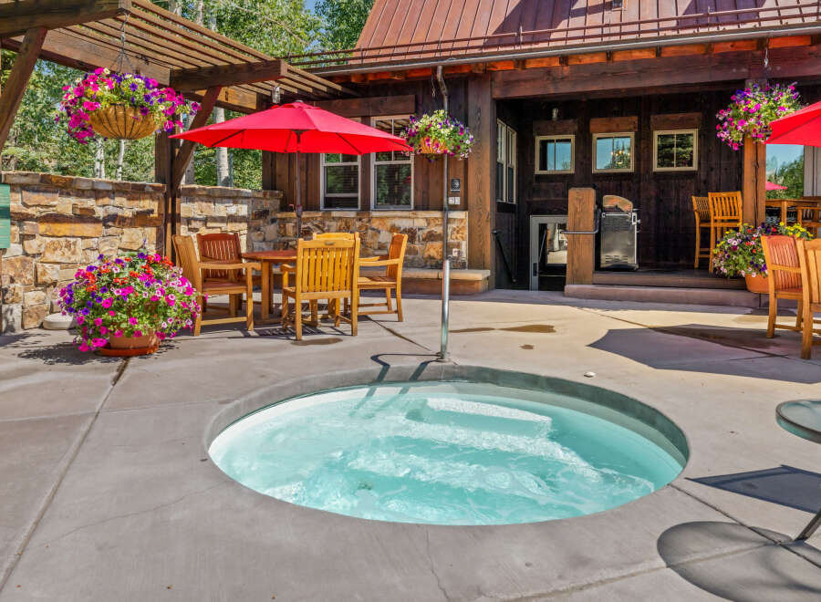 Enjoy ultimate relaxation in this inviting outdoor space, featuring a bubbling hot tub perfect for unwinding.