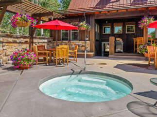 Enjoy ultimate relaxation in this inviting outdoor space, featuring a bubbling hot tub perfect for unwinding.