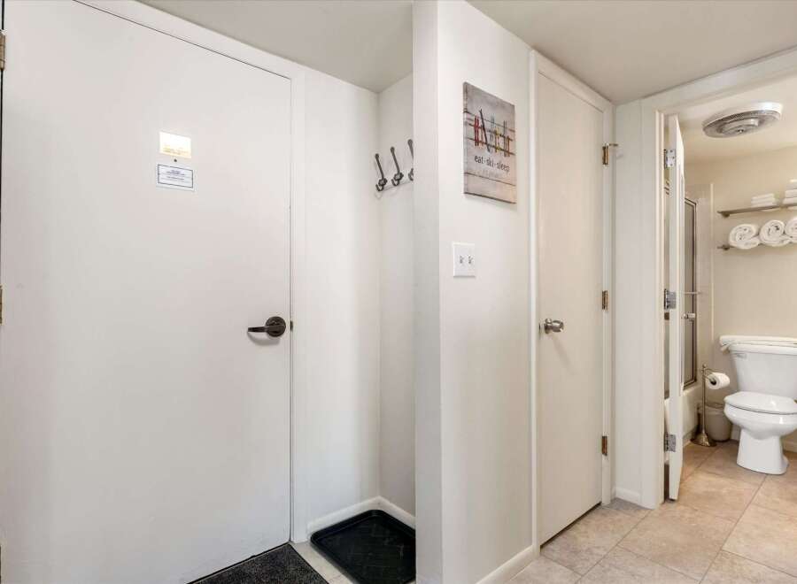 Step into this charming property featuring a convenient entryway with coat hooks and a boot tray, perfect for mountain getaways.