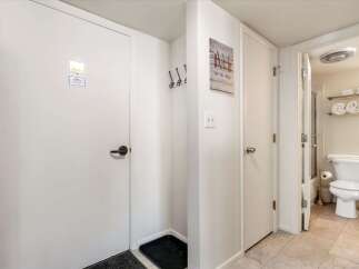 Step into this charming property featuring a convenient entryway with coat hooks and a boot tray, perfect for mountain getaways.
