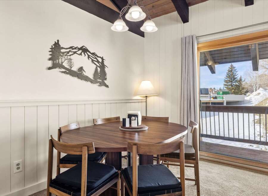 Enjoy cozy meals in this charming dining area, featuring a beautiful wooden table and chairs perfect for family gatherings.