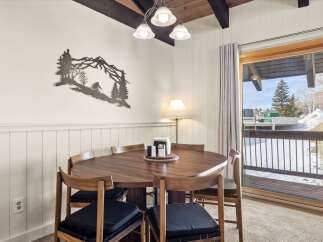 Enjoy cozy meals in this charming dining area, featuring a beautiful wooden table and chairs perfect for family gatherings.