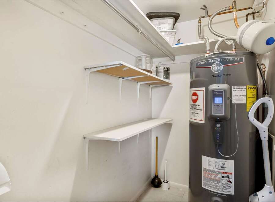 Discover this well-maintained utility space featuring a Rheem Performance Platinum water heater, ensuring reliable hot water for your home.