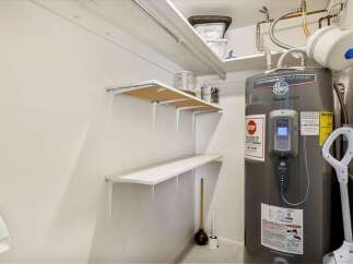 Discover this well-maintained utility space featuring a Rheem Performance Platinum water heater, ensuring reliable hot water for your home.