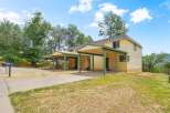 Discover this charming property featuring a bright yellow exterior and convenient covered parking.