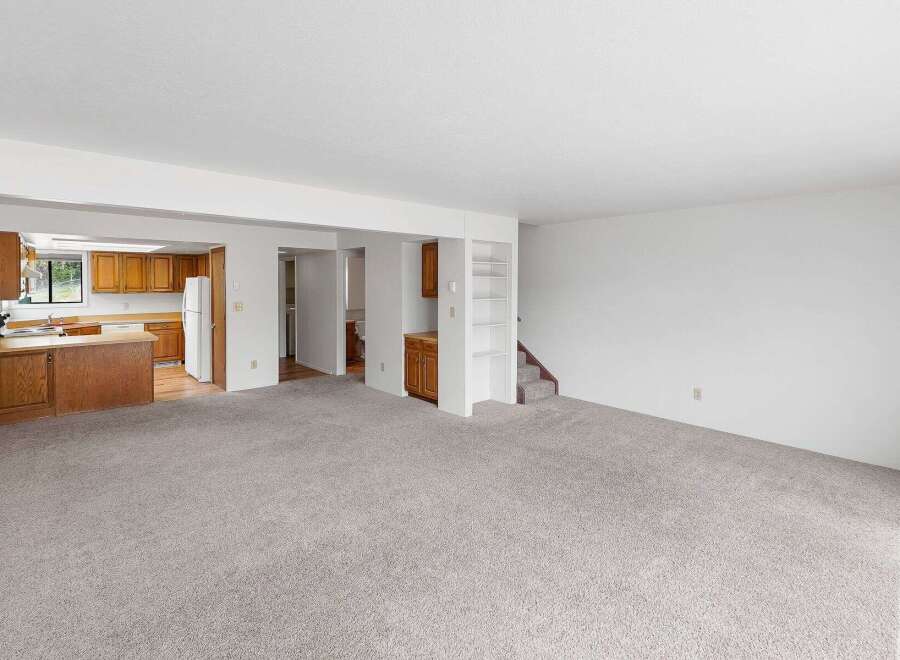 Discover comfortable living in this spacious open-concept home, featuring a well-appointed kitchen with ample cabinetry and a convenient breakfast bar.