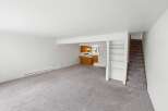Step into this spacious living area featuring plush carpeting and a convenient heating unit.