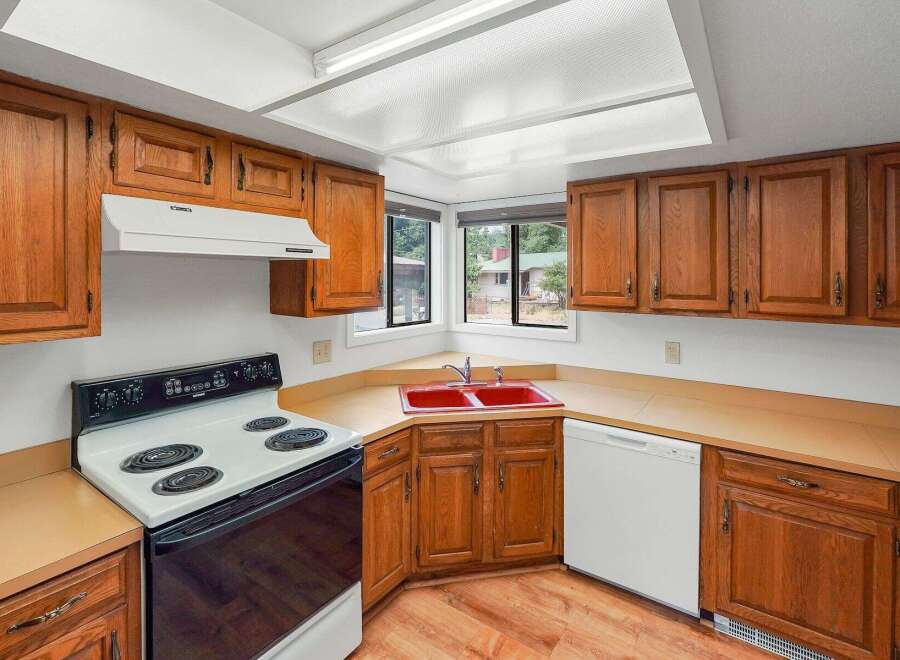 This kitchen features warm, honey-toned wood cabinetry that offers ample storage space.