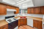 This kitchen features warm, honey-toned wood cabinetry that offers ample storage space.