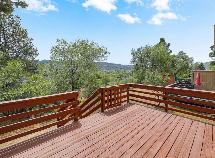 Enjoy the stunning natural beauty from this expansive wooden deck, perfect for outdoor entertaining or quiet relaxation.