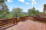 Enjoy the stunning natural beauty from this expansive wooden deck, perfect for outdoor entertaining or quiet relaxation.