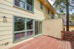 Enjoy the outdoors from this charming home featuring a spacious wooden deck perfect for entertaining.