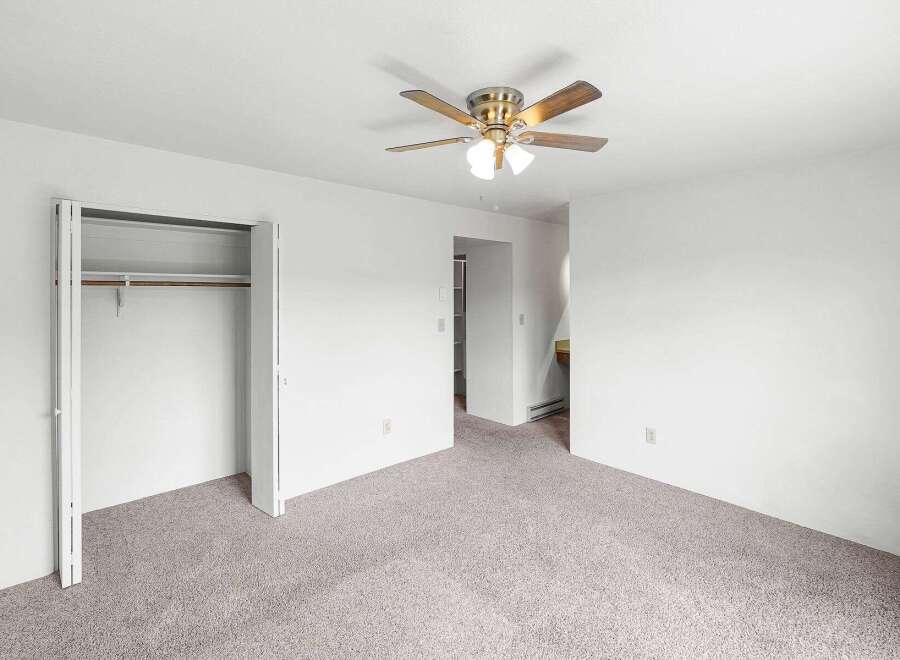 Discover comfort and convenience in this spacious room featuring a ceiling fan for optimal air circulation and ample closet space for all your storage needs.