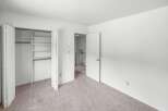 Discover ample storage in this spacious bedroom featuring a large closet with built-in shelving.