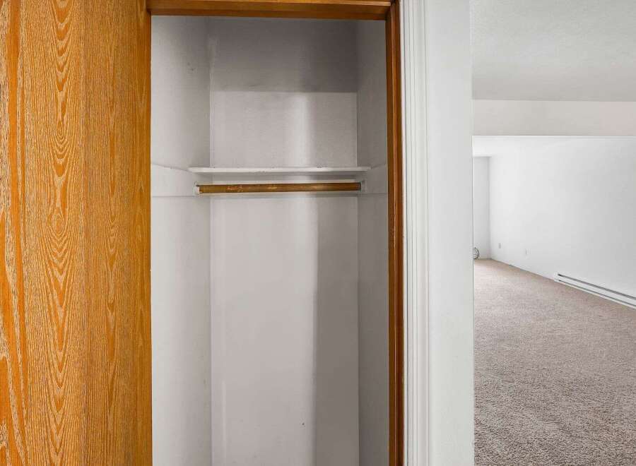 Discover ample storage with this spacious closet, featuring a convenient shelf and hanging rod.