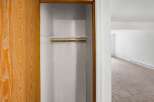 Discover ample storage with this spacious closet, featuring a convenient shelf and hanging rod.