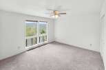 Experience breathtaking views from this spacious bedroom, featuring large windows that frame the picturesque landscape.