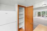 Discover ample storage in this home with a spacious pantry featuring multiple shelves, perfect for organizing your kitchen essentials.