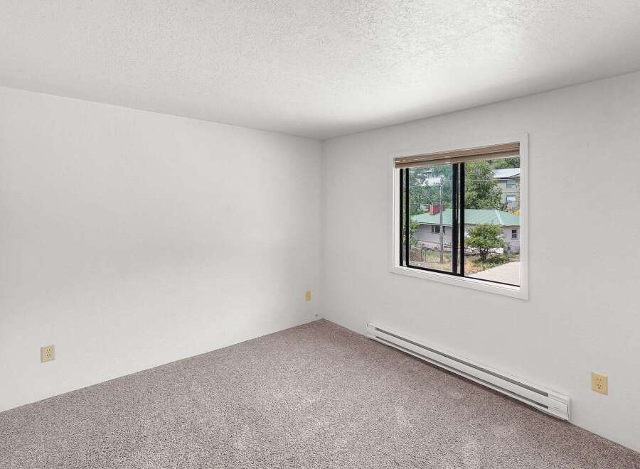 This spacious room features neutral carpeting and clean white walls, creating a versatile canvas for your personal style.