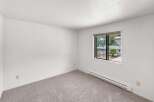 This spacious room features neutral carpeting and clean white walls, creating a versatile canvas for your personal style.