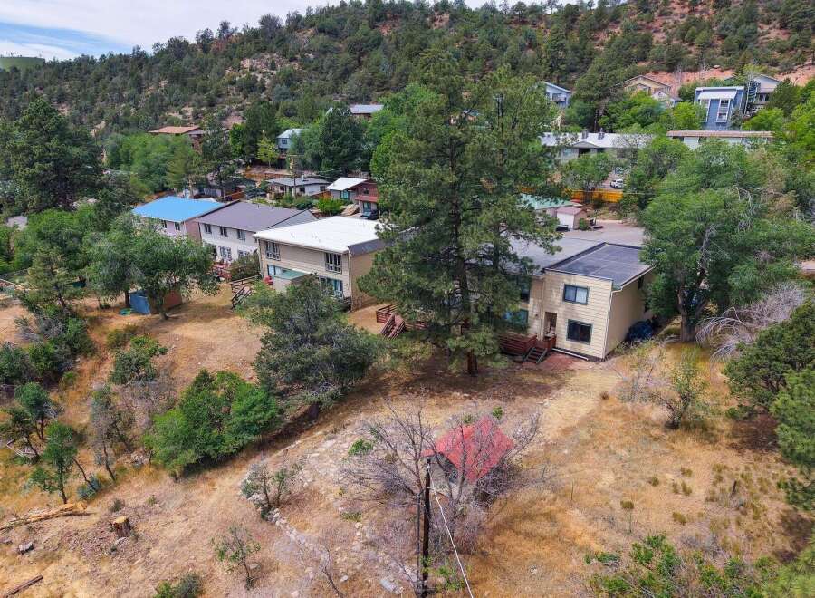 Discover this charming property nestled on a hillside, offering a unique blend of natural beauty and comfortable living.