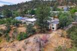 Discover this charming property nestled on a hillside, offering a unique blend of natural beauty and comfortable living.