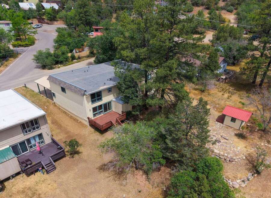 Discover this charming property featuring a spacious two-story home with a large wooden deck, perfect for outdoor entertaining.