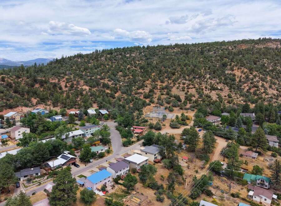 Discover this charming residential area nestled against a scenic hillside, offering a peaceful retreat with stunning natural surroundings.