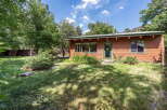 Charming wooden cabin nestled amongst mature trees, offering a serene retreat.