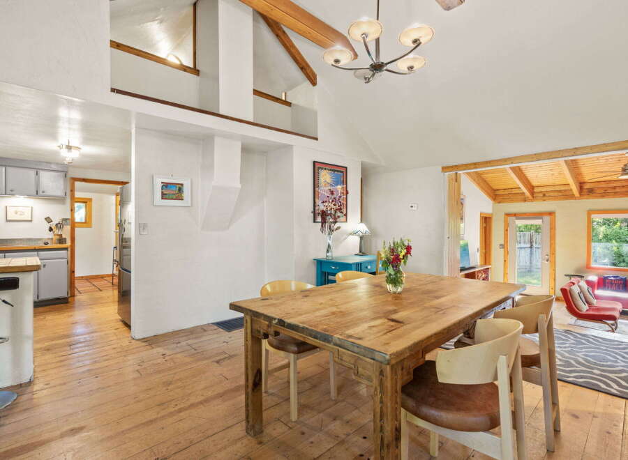 Experience rustic charm in this inviting dining area, featuring a substantial wooden table perfect for gatherings.