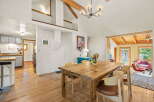Experience rustic charm in this inviting dining area, featuring a substantial wooden table perfect for gatherings.