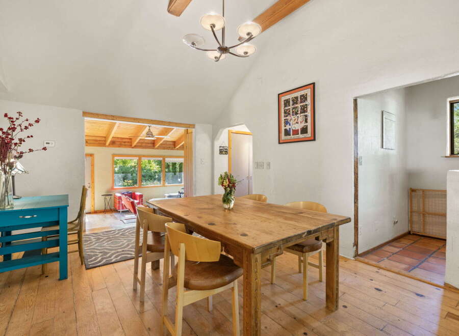This charming dining area features a rustic wooden table with four chairs, perfect for intimate gatherings.