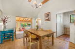 This charming dining area features a rustic wooden table with four chairs, perfect for intimate gatherings.
