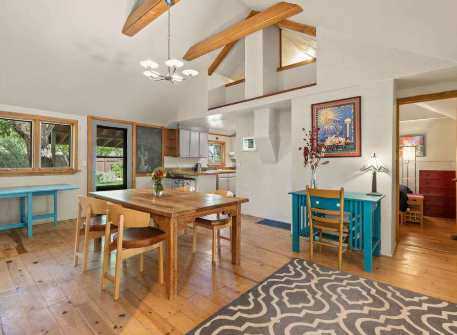 This charming dining area features a rustic wooden table with four chairs, perfect for intimate gatherings.