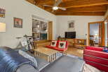 Experience comfortable living in this inviting space, featuring a spacious living area with a mounted TV and a cozy seating arrangement.