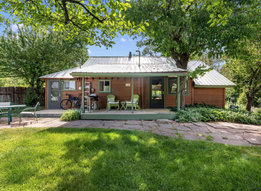 Charming rustic cabin nestled amongst mature trees, offering a serene getaway.