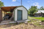Discover a charming backyard with a versatile shed, perfect for storage or a workshop.