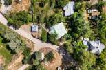 Discover this expansive property featuring multiple structures nestled amongst mature trees.