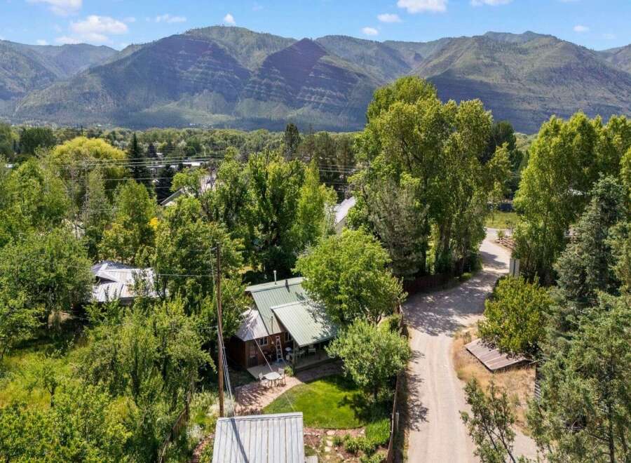Nestled amidst lush greenery and mature trees, this charming property offers a serene mountain retreat.