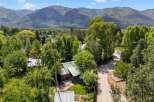 Nestled amidst lush greenery and mature trees, this charming property offers a serene mountain retreat.