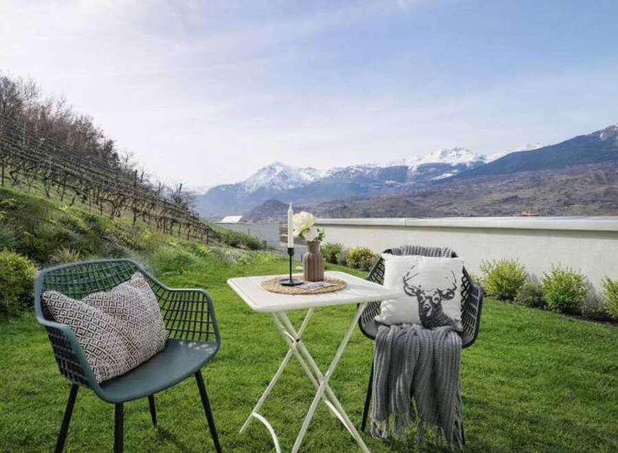 Enjoy breathtaking mountain views from this charming outdoor seating area, perfect for relaxing or entertaining.