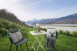 Enjoy breathtaking mountain views from this charming outdoor seating area, perfect for relaxing or entertaining.