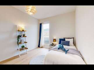 Discover this charming bedroom featuring a cozy single bed adorned with plush pillows and a playful shark plushie.