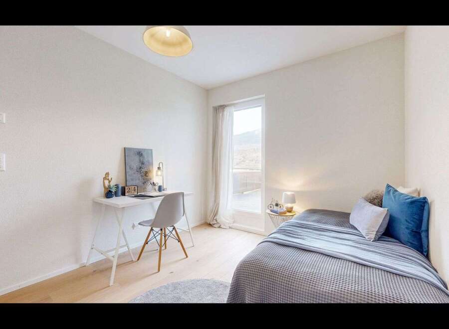Discover this charming bedroom featuring a cozy bed with plush blue and grey bedding, perfect for relaxation.