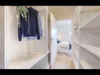 Step into a spacious walk-in closet featuring ample shelving and hanging space, perfect for organizing your wardrobe.