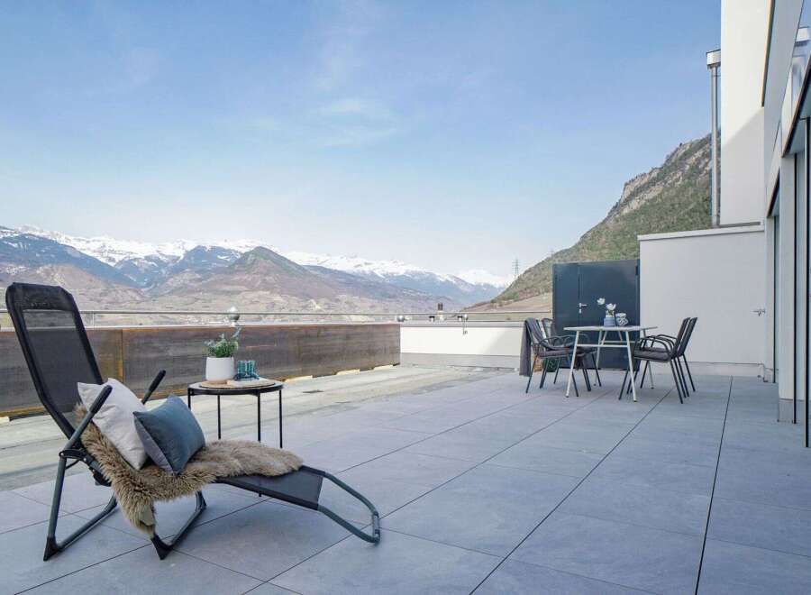 Experience breathtaking mountain views from this stunning modern terrace, perfect for outdoor relaxation and entertaining.
