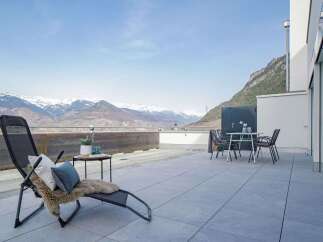 Experience breathtaking mountain views from this stunning modern terrace, perfect for outdoor relaxation and entertaining.