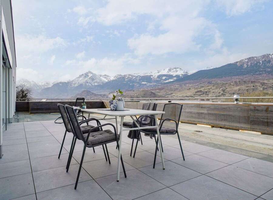 Enjoy breathtaking mountain views from this stunning patio, perfect for outdoor dining and relaxation.