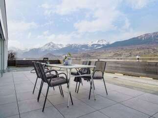 Enjoy breathtaking mountain views from this stunning patio, perfect for outdoor dining and relaxation.