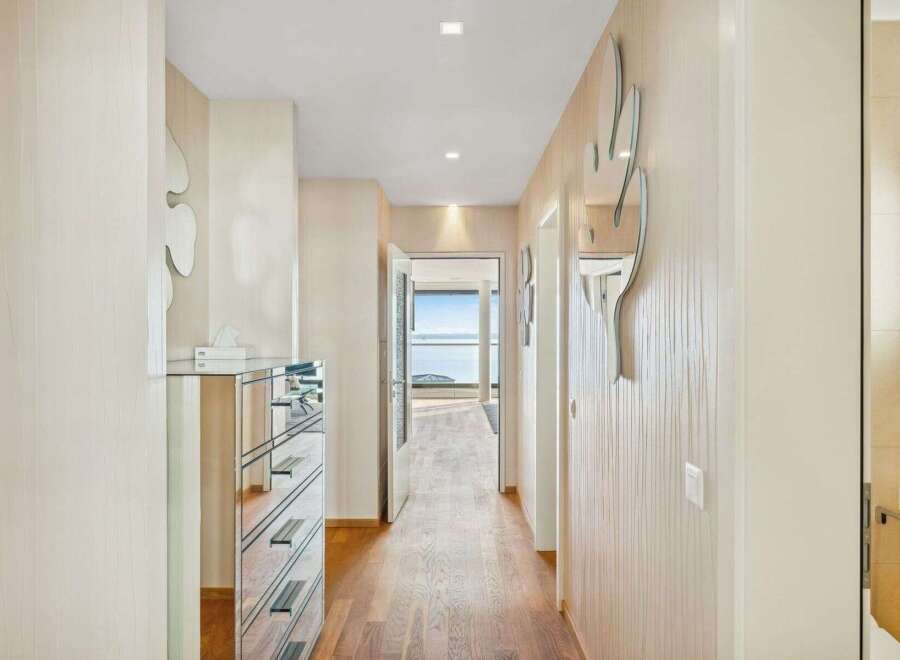 Step into this elegant hallway featuring a mirrored dresser and unique cactus-shaped wall mirrors, adding a touch of modern flair.